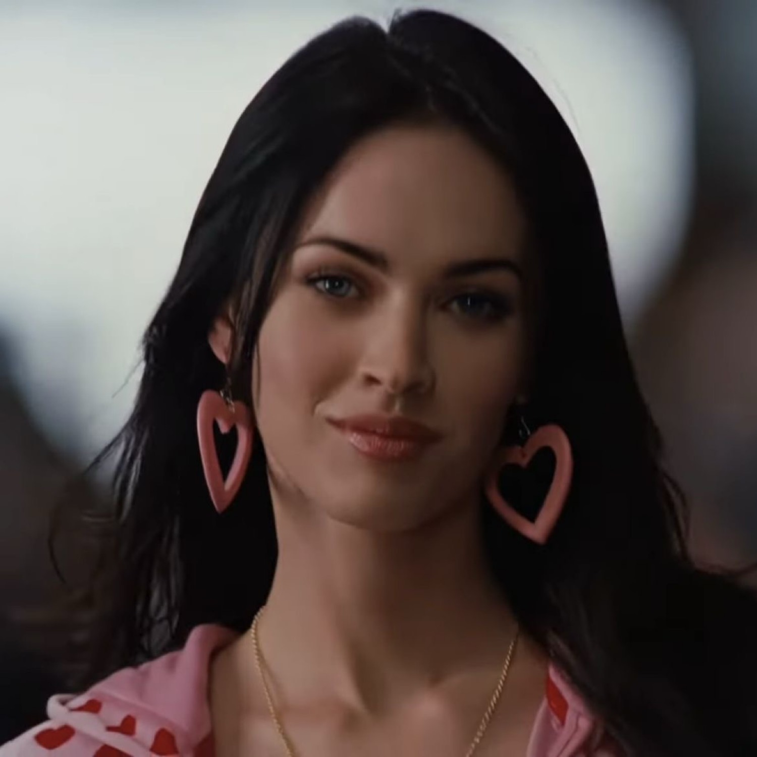jennifer check wearing heart earrings and a pink hoodie