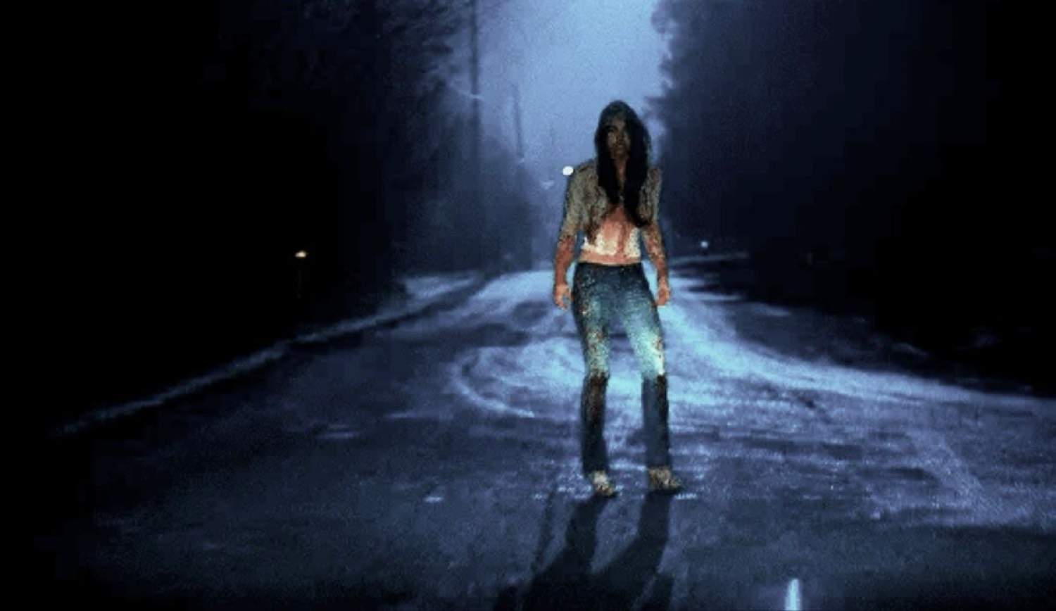 jennifer standing in the road at night after the woods